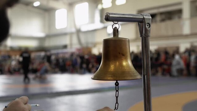 Striking a boxing gong bell before the start 