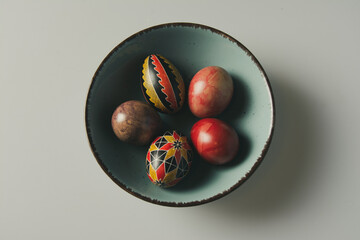 Easter eggs in a bowl on a light background with copy space