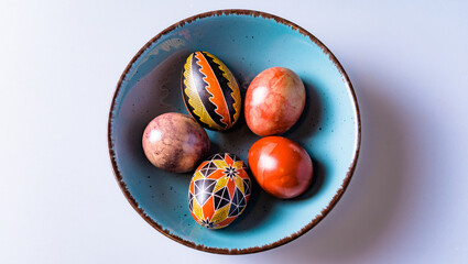 Easter eggs in a bowl on a light background with copy space
