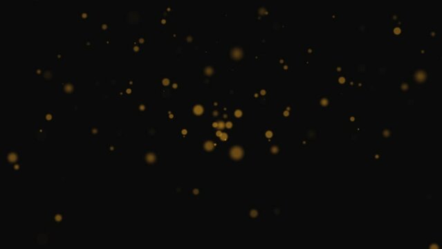 Gold Dust Particles Fly in Slow Motion, Lingering Slowly in the Air. Dust Particles Background with Bokeh Lights on Black Background