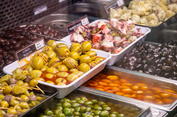 Buying olives in central market in Valencia, Spain