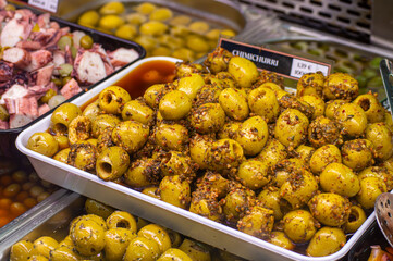 Buying olives in central market in Valencia, Spain