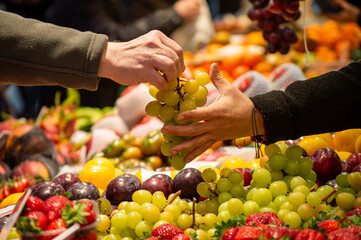 Buying vegetables and fruits in central market in Valencia, Spain