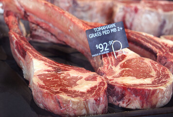 Two Grass-Fed Beef Tomahawk Steaks on display