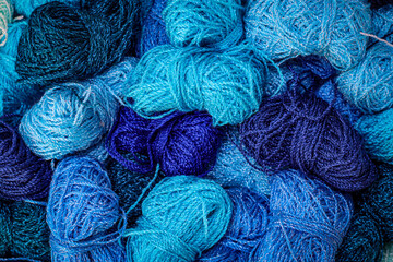 Texture of various shades of blue matte crystal thread.