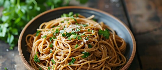 A delicious bowl of al dente noodles with sauce and parsley, served on a rustic wooden table.