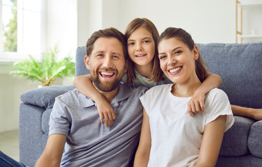 Close up portrait of cheerful smiling happy family sitting in the living room at home with their...