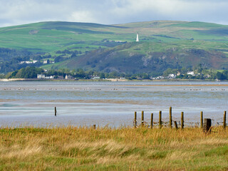 Hoad Hill and Canal Foot in Ulverston viewed across Morecambe Bay from Sandgate near Flookburgh.