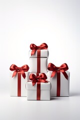 Vertical image of four white gift boxes decorated with red ribbons isolated on a white background