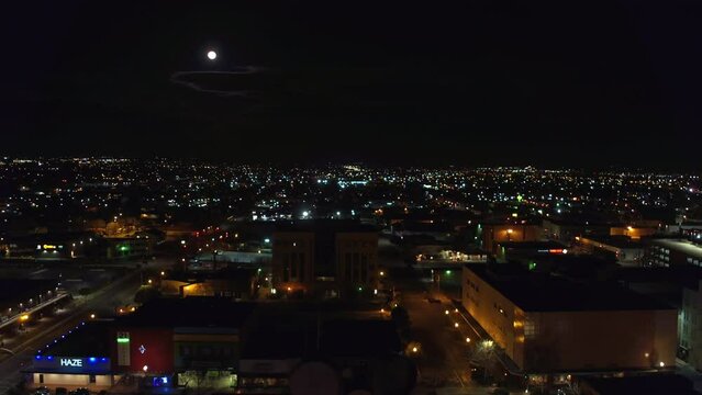 Aerial Forward Shot Of Illuminated Residential City Against Moon In Sky During Tranquil Night - Bakersfield, California