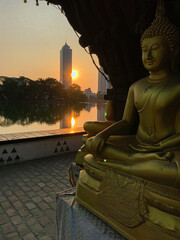 golden buddha statue with sun set