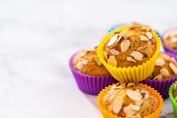 Lemon poppy seed muffins garnished with almond slivers