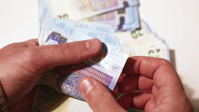 Counting the money in hands. 20 euro bills. Stacks of banknotes on the table. Close-up stock video