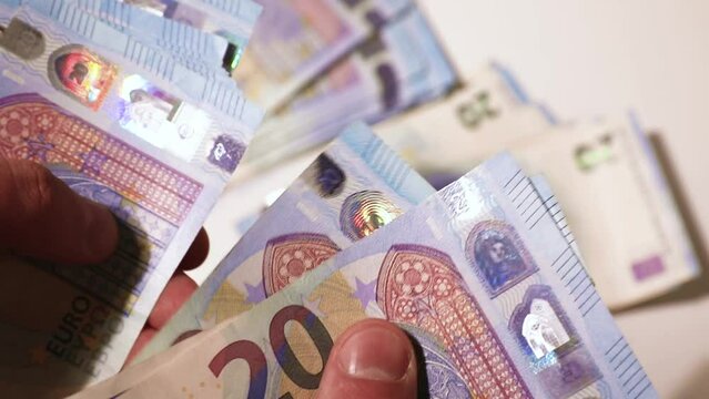Counting the money in hands. 20 euro bills. Stacks of banknotes on the table. Close-up stock video