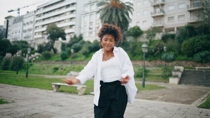 Funky woman dancer enjoy freestyle performance on city street. Girl performing