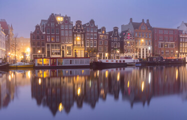 Fototapeta na wymiar Typical houses and bridge at Amsterdam canal Brouwersgracht at night, Holland, Netherlands