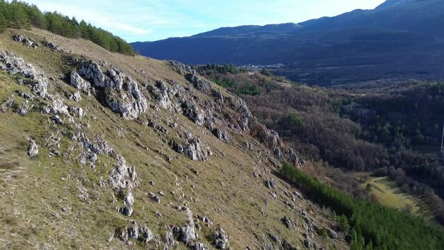 4k drone footage of a cliffside in the mountains near L'Aquila, Abruzzo, Central Italy.