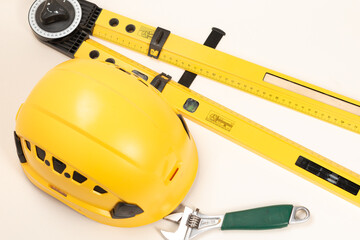 Construction concept. Yellow safety helmet, construction sites. Business and industry concept. Copy space for design.Helmet with construction tools on white background 