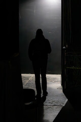 Figure of a stranger. Go away from the camera. Man in the Dark. Exit to the stage. The start of the journey. Step into the unknown. Back view of a man. Back view of a silhouette of a man.