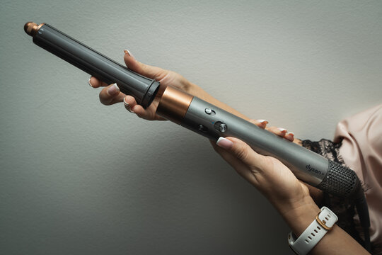 Estonia, Tallinn February 9, 2024.  Luxury hair dryer Dyson airwrap in women's hands.