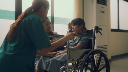 girl sitting on a wheelchair in a hospital crying