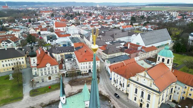 Aerial of church tower with rooster at Stiftskirche in Altoetting in circular motion
