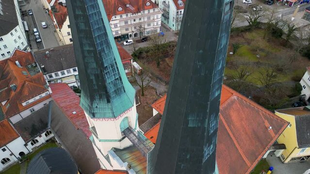 Drone rising along church tower of Stiftskirche in Altoetting