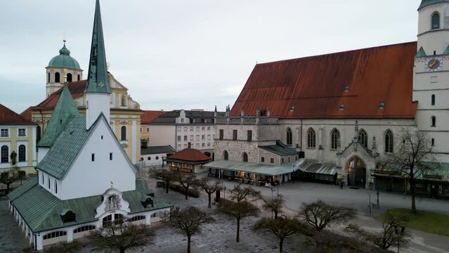 Drone rising straight up at Kapellplatz in Altoetting in front of Gnadenkapelle in winter