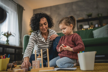 Mother and daughter toddler child play at home