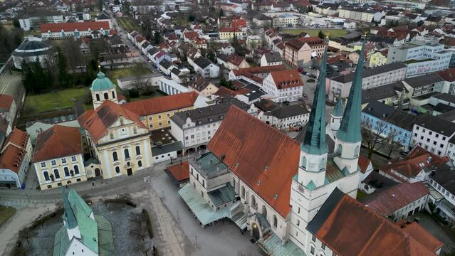 Sinking drone shot of Stiftskirche in Altoetting with church towers in focus