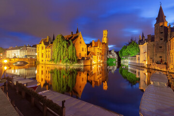 Medieval fairytale town and tower Belfort from quay Rosary,at night, Bruges, Belgium