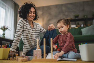 Mother and daughter toddler child play at home