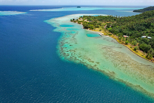 Aerial view of the coral reef, South Pacific Ocean, and the island of Raiatea near the Marae Taputapuatea in Opoa on the south eastern coast of Raiatea