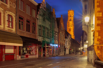 Medieval Old town, street and tower Belfort at night, Bruges, Belgium