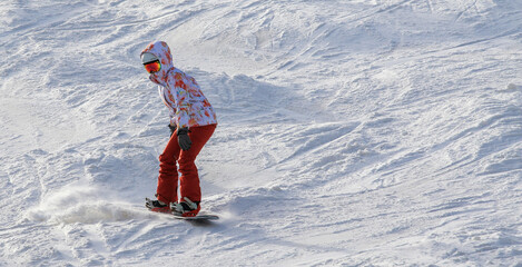 Female snowboarder all alone on a ski slope