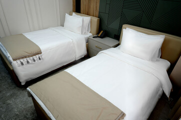 The interior of a hotel room with two beds.