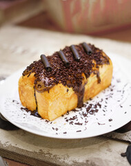 Fresh grilled delicious sandwich with topping and filling plated in white plate, just freshly baked