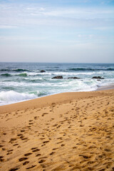 beach in the morning, waves with rocks
