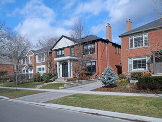 Residential street with traditional two story brick houses - 732091424
