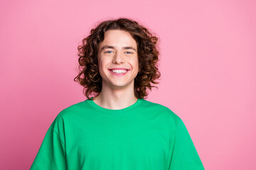 Closeup photo of young handsome teenage curly guy wearing green stylish t shirt with non branding...