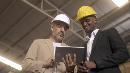 Businessman checking warehouse with staff