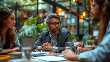 Business team working on a project in the office behind a table or reviewing and discussing a business project. IT workers in the office