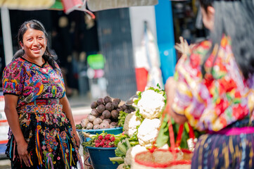 Two Latin women talk in a Latin American market.