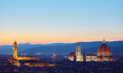 Fototapeta na wymiar Florence, Tuscany, Italy. Panorama Sunset view at Duomo Santa Maria del Fiore cathedral and Palazzo Vecchio Tower. Panoramic of Firenze during sunset. Scenic landscape mountains evening sky.