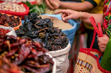 Woman's hands buying in a spice market.