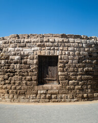 Amman, Jordan - October 9 2022 : Odeon theatre in the Hashemite plaza. A brick fortress ruin turret in bright sunlight. Stone castle wall no people copy space