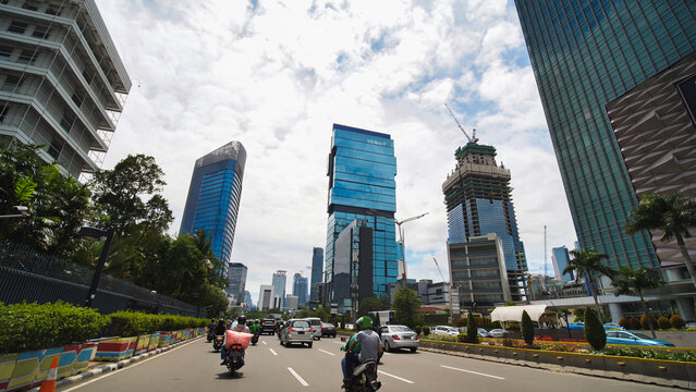 Jakarta's roads and streets with cars during the daytime.