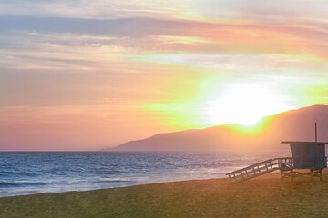 Sunset over mountains at Zuma Beach in Malibu California 