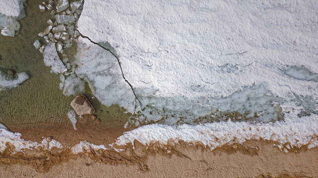 Drone shot of Georgian Bay Ice Pack Breaking Up and Melting in February when unseasonably warm - Powered by Adobe