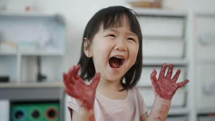 Little girl enjoys playing with colors.